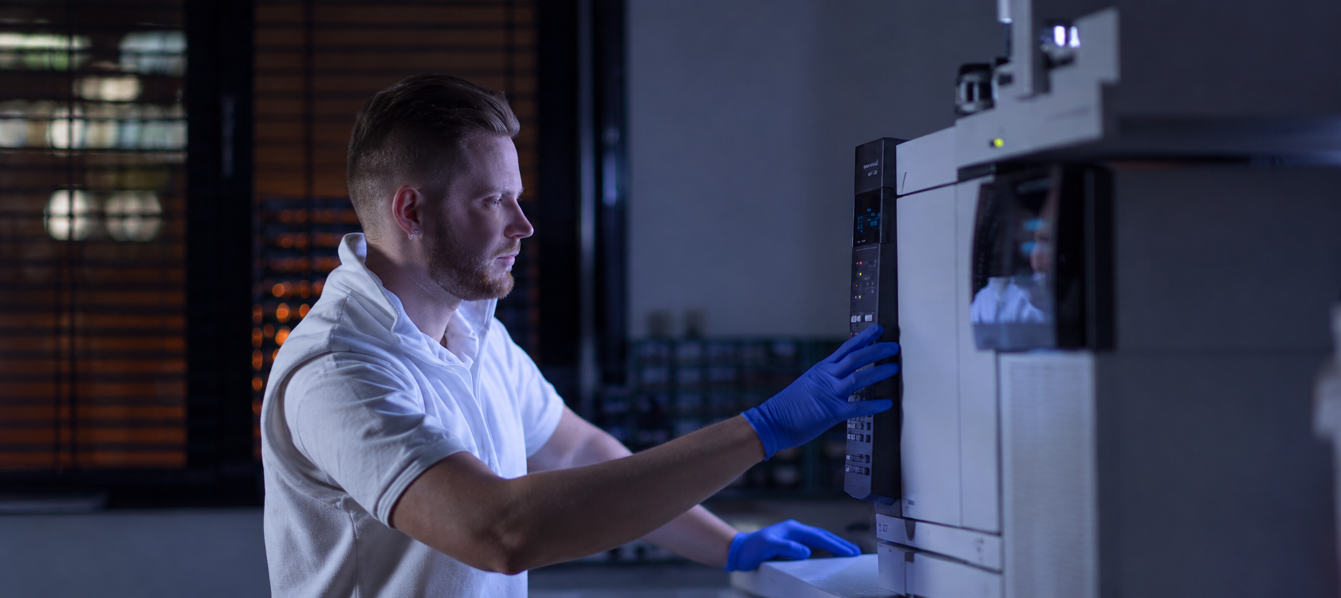 Scientist with blue liquid pipette in laboratory